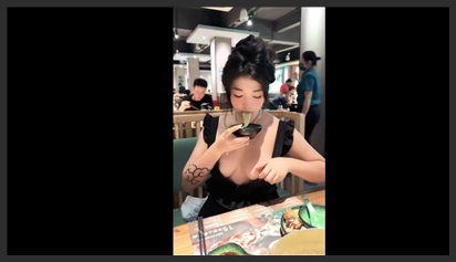 Horny girl showing off boobs at a restaurant