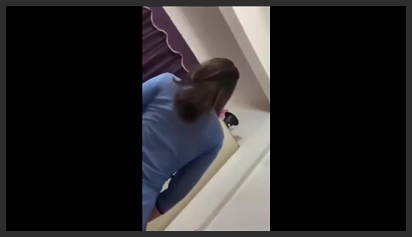 Full clip of a very attractive teacher in a blue shirt